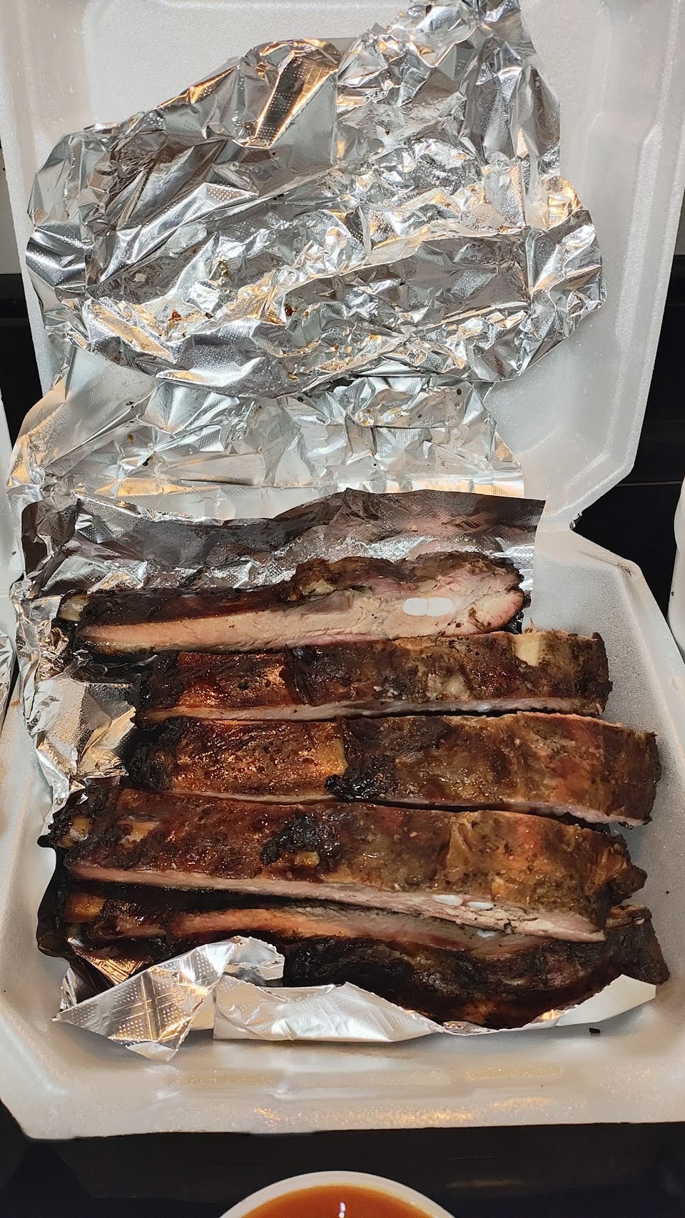 Pulled pork, ribs, and sausage options.